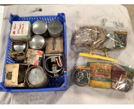 A box of various pistons and two bags of various piston rings.