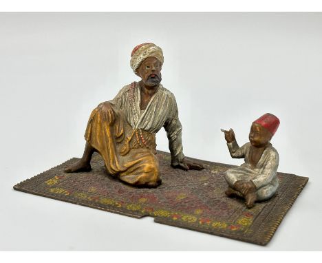 Wiener Bronze. Orientalen auf Teppich. 1. Hälfte 20. Jahrhundert.Circa 7,5 cm x 8,5 cm x 12,5 cm. Bronze. Polychrom bemalt. D