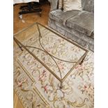 A rectangular Hollywood regency style coffee table finished in bronzed metal the tempered glass