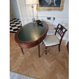 Regency style Mahogany oval shaped writing table featuring gilt tooled leather top with single