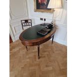 Regency style Mahogany oval shaped writing table featuring gilt tooled leather top with single