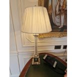 A French Empire style Corinthian Column lamp nickel and glass raised on a stepped base with