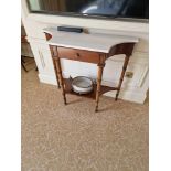 A Regency style mahogany console table. The white marble top with concave sides above a central