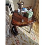 A George III style small mahogany and satinwood inlaid oval Pembroke table. The top and dual