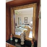 A large overmantel gold mirror with egg and dart motive The frame has an overlapping inserted sub-