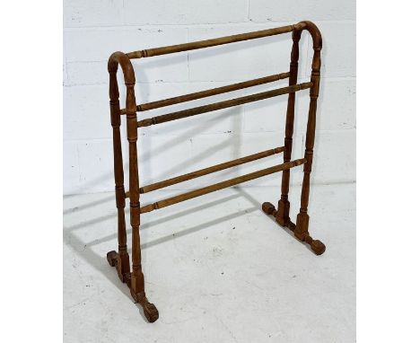 A vintage wooden towel rail with turned supports 