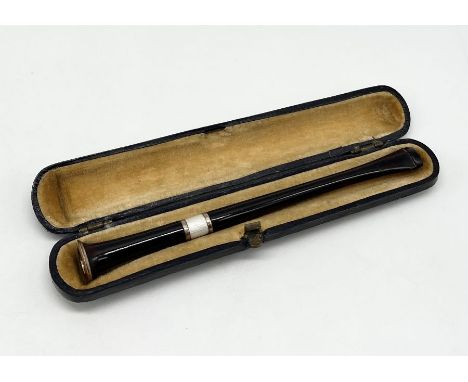 A cased cheroot/cigarette holder in gold mount and guilloche enamel