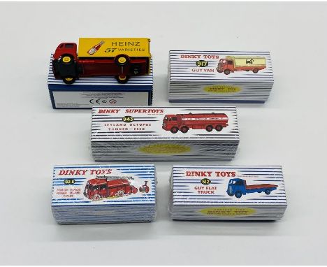 Three boxed modern Atlas Mattel Dinky Toys die-cast vehicles including Guy Van (917), Guy Flat Truck (512) and First Aid Fire