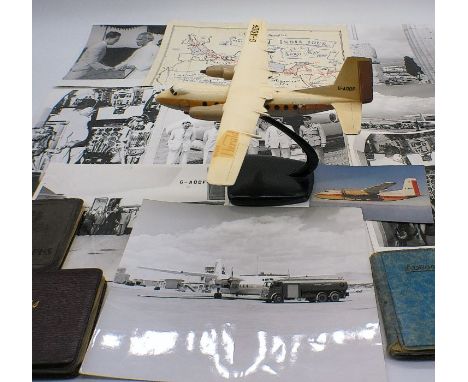 A model plane (propeller blades missing) and a collection of photographs documenting the 14000 mile journey undertaken by Han