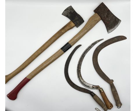 A collection of tools including two axes, one made in Sweden, and three sickles all named