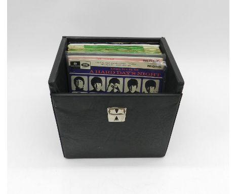 A collection of 7" vinyl records by The Beatles and related artists contained within a vintage carry case