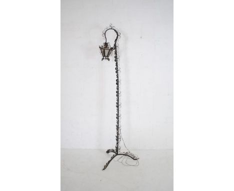 An ornate wrought iron standard lamp - height 199cm