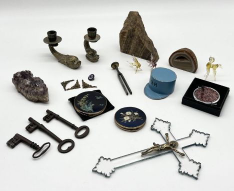 A collection of miscellaneous items including geodes, compacts, antique keys, brass candle holders in the form of stylised do