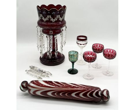 A Victorian ruby glass lustre along with a collection of bohemian glass goblets and red and clear glass rolling pin 