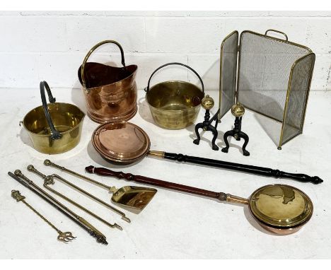 A collection of brass and copper including coal bucket, fire dogs, fire screen etc. 