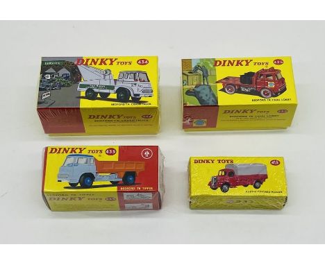 Four boxed modern Atlas Mattel Dinky Toys die-cast vehicles including a Bedford TK Coal Lorry (425), Bedford T.K Crash Truck 