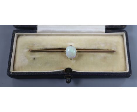 An early 20th century 9ct and white opal set bar brooch, 6cm.