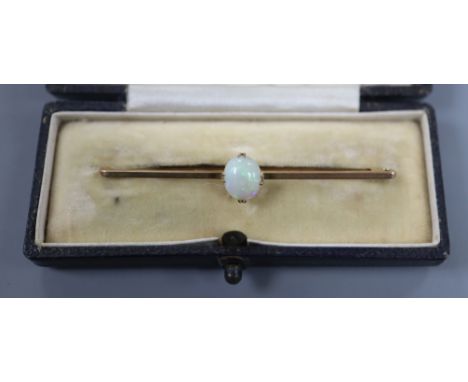 An early 20th century 9ct and white opal set bar brooch, 6cm.