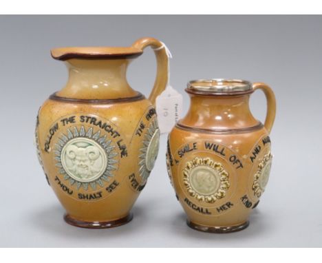 Two Doulton Lambeth motto jugs, c.1890, both with mask and portrait medallions, the largest with motto 'STRAIGHT IS THE LINE 