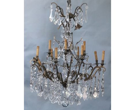 An Italian bronze and cut glass twelve light chandelier, overall drop 4ft., diameter 3ft