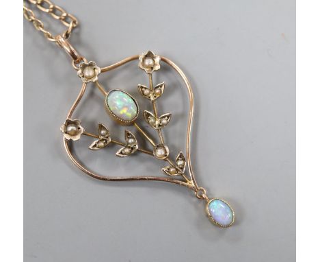 An Edwardian 9ct, white opal and seed pearl set pendant, on a gilt metal chain, pendant 37mm.