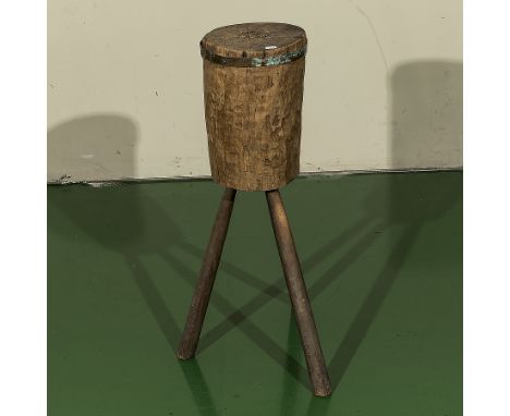A vintage tripod chopping block