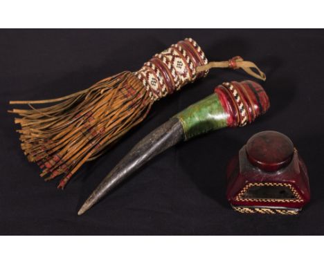 An African tribal horn dagger with leather work handle and sheath together with a leather covered ink bottle