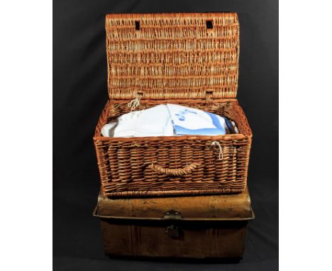 A basket and a trunk of vintage linen