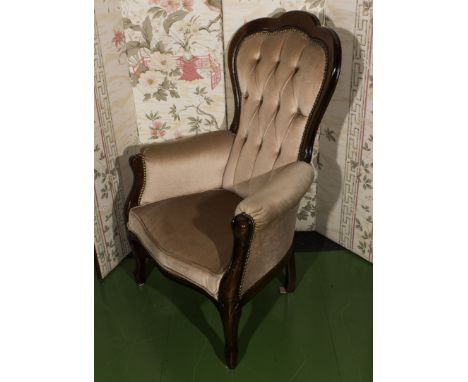 A reproduction button backed armchair.