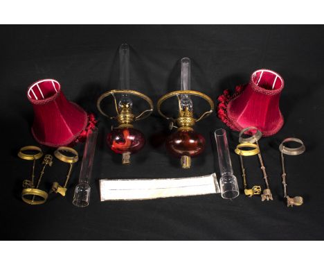 Two cranberry glass oil lamp fittings together with other related items