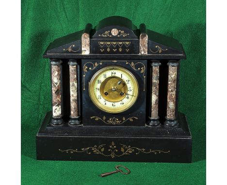 A Victorian black slate mantle clock