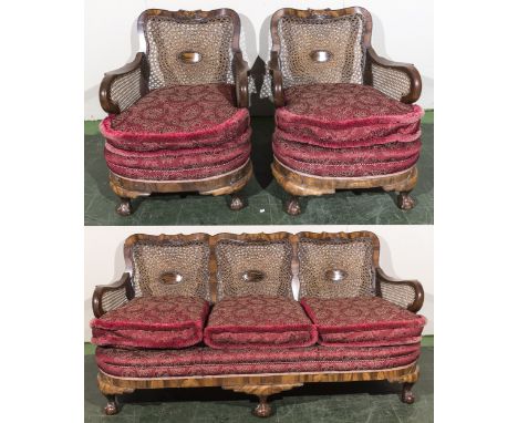 A walnut framed bergere three seater sofa and two matching arm chairs