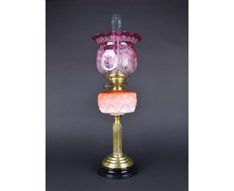 A Late Victorian Brass Oil Lamp, with Opaque Pink Glass Reservoir, And Etched Cranberry Shade, Support in the Form of A Reede