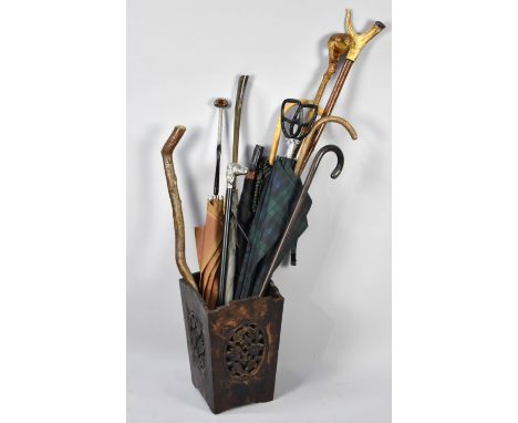 An Edwardian Carved and Pierced Stick and Umbrella Stand Containing Walking Sticks, Parasols, Umbrellas etc 