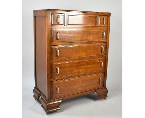 An Art Deco Oak Gentleman's Bedroom Chest with Lift Top Having Inner Mirror, Two Short and Four Long Drawers, Ogee Bracket Fe