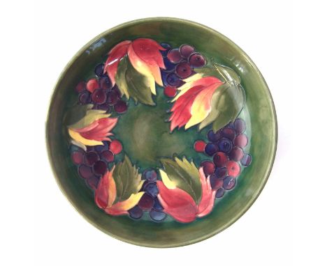Moorcroft bowl, decorated with Leaves and Berries pattern on green ground, impressed and painted marks to base, 26cm diameter