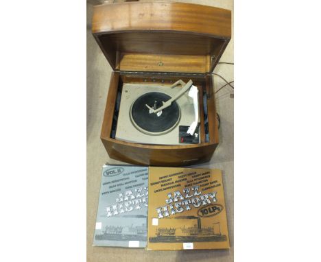 A Pye 'Black Box' record player in mahogany finish case and two records, Jazz History Vols I and II.
