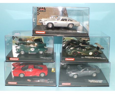 Five Carrera Evolution Scalextric style slot cars, including two James Bond 007 cars, all boxed.