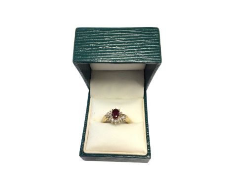 18ct gold ruby and diamond cluster ring with an oval mixed cut ruby surrounded by fourteen brilliant cut diamonds, estimated 