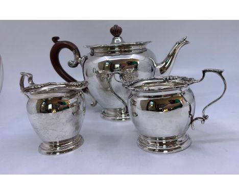 A sterling silver tea set comprising teapot, milk jug and sugar. Circular bullet teapot, with raised edging above the lid, wh