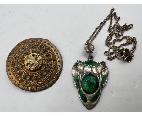 An Arts and Crafts/ Art Nouveau style green enamel foliate pendant, marked "Silver" and the letters "CVB" in a stylised logo,