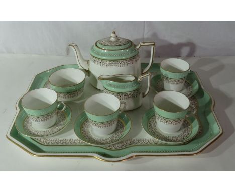 A late 19th century tea service for four people with beaded border on an apple green ground with gilt line comprising four cu