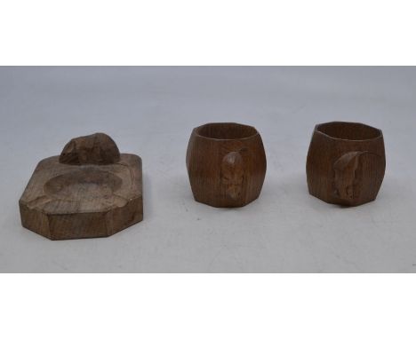 Workshops of Robert Mouseman Thompson, a pair of oak octagonal napkin rings, 5cm(H); together with an oak hexagonal ashtray 1