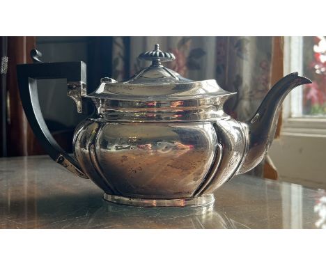 A George V silver teapot, by John Turton &amp; Co, hallmarked 1919 for Sheffield. Oval shaped with fluted panels. Has a few s