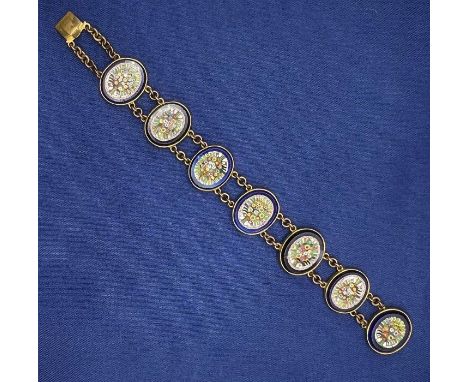 A vintage micro mosaic panel bracelet in yellow metal, assessed as base metal, with each panel depicting a bouquet of flowers
