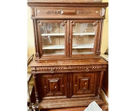 A 20th century oak dresser, moulded cornice, over twin panel doors, foliage carving throughout, fitted on a three quarter gal