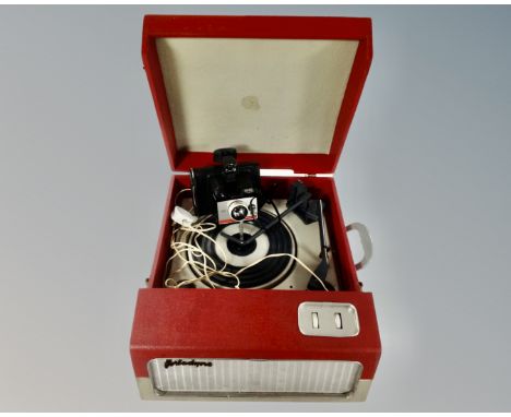 A mid-20th century Portadyno electric tabletop record player together with a vintage Polaroid camera.