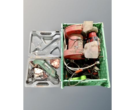 A crate containing PowerDevil and Wolf Power bench grinders, Bosch sander in case, glue guns, clamps etc.