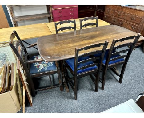 An Ercol elm and beech refectory dining table together with a set of five ladder back chairs, one carver four singles, in an 