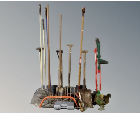 A Qualcast electric strimmer together with a quantity of garden tools.